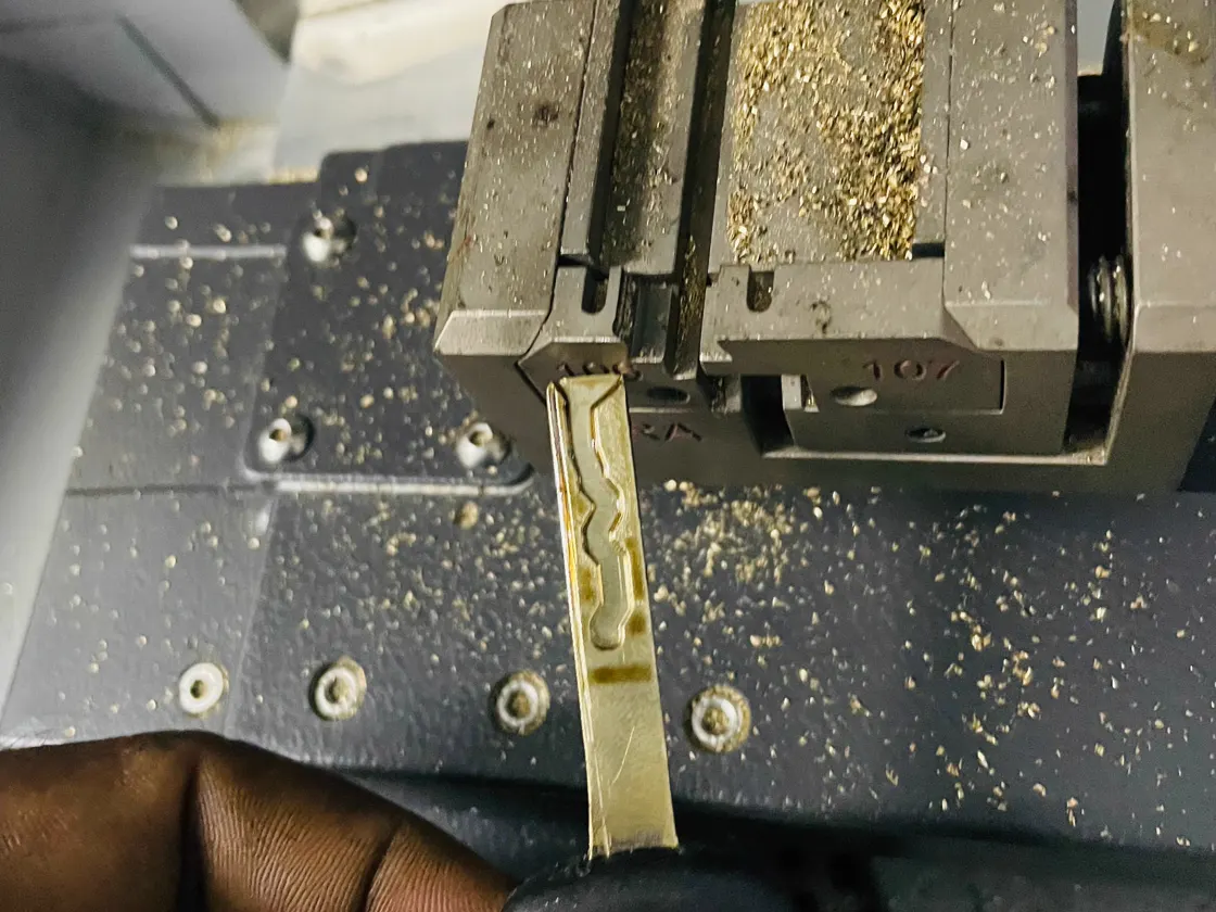 Vehicle key blade beside a cutting machine