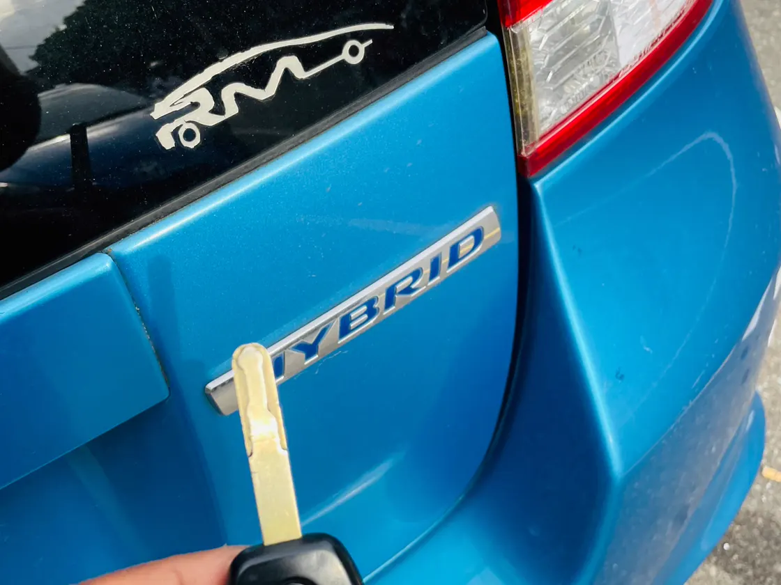 Key blade beside a Honda hybrid