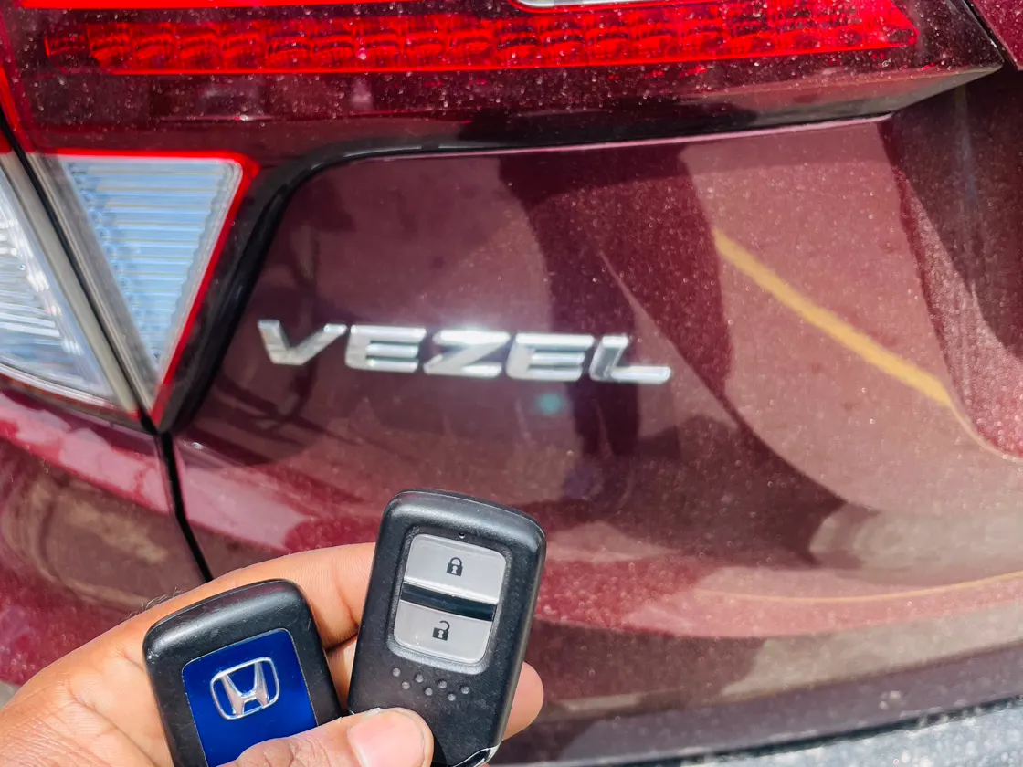 Smart-key fobs beside a Honda Vezel